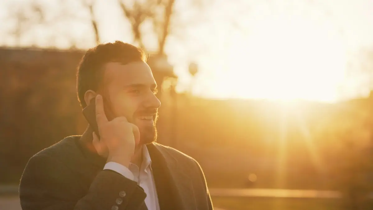 A customer on a phone call at dusk